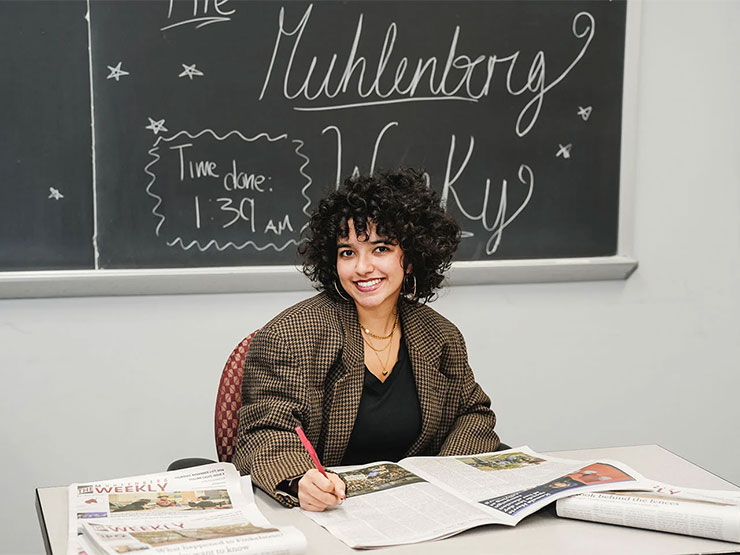 Keanna Peña smiles while making edits to the The Muhlenberg Weekly student newspaper.