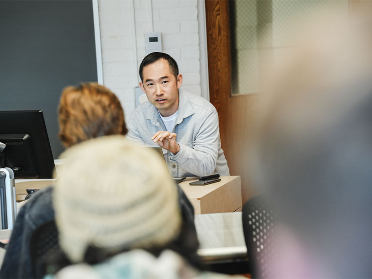Computer science instructor Youngsun Jang speaks to students in his classroom.