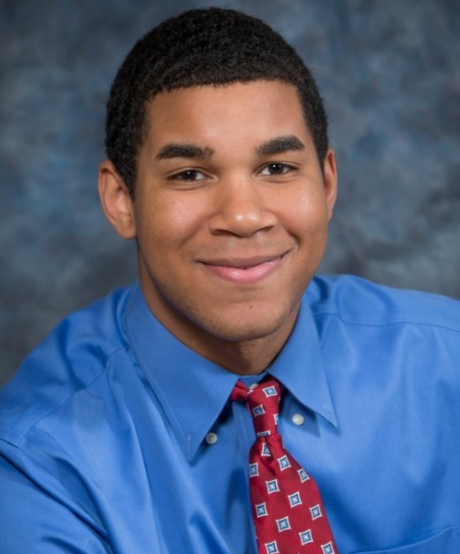 A professor in a blue button down shirt with a red patterned tie. The professor is Dr. Wyatt Dawson,