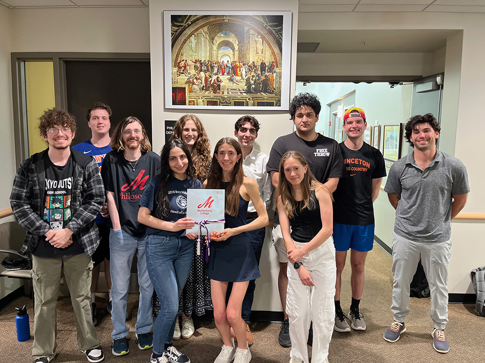 Group of students in the international philosophy honors society, Phi Sigma Tau students posed standing indoors together.