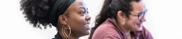 Two students smiling in a classroom