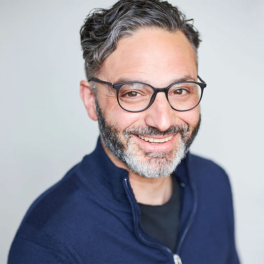 Zachary Mannheimer smiles in a professional headshot