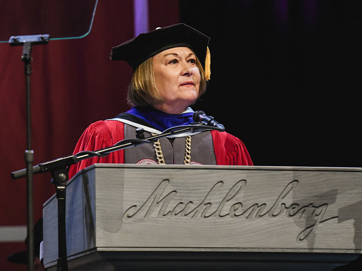 Muhlenberg College President Kathleen Harring speaks from behind a podium during commencement.