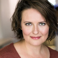 A headshot of Jessie Dean, who has chin-length brown hair