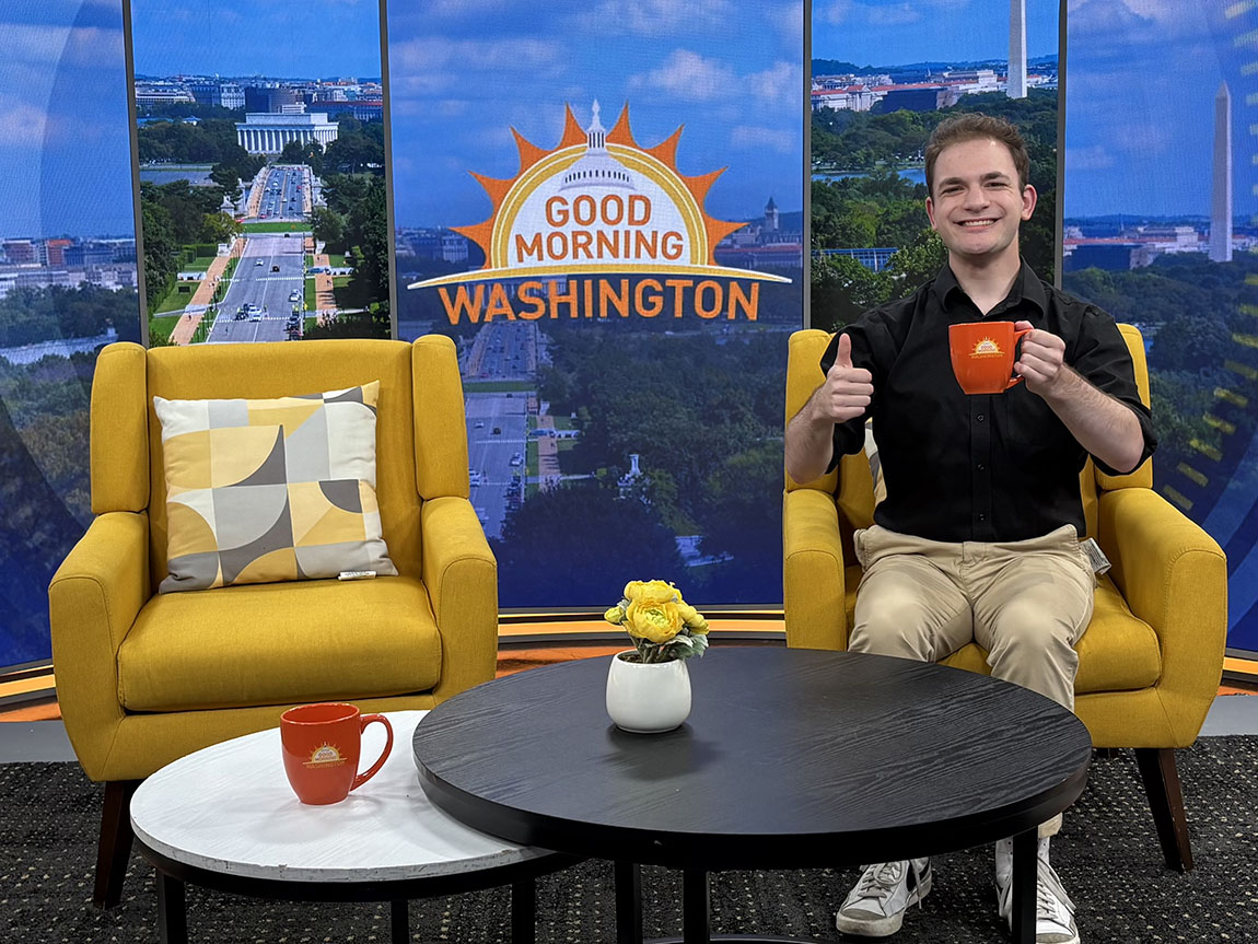 A college student gives a thumbs up on the set of Good Morning Washington