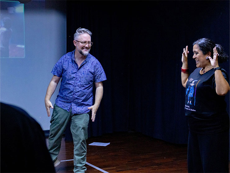 A pair of Muhlenberg professors work together in a black box theatre space.